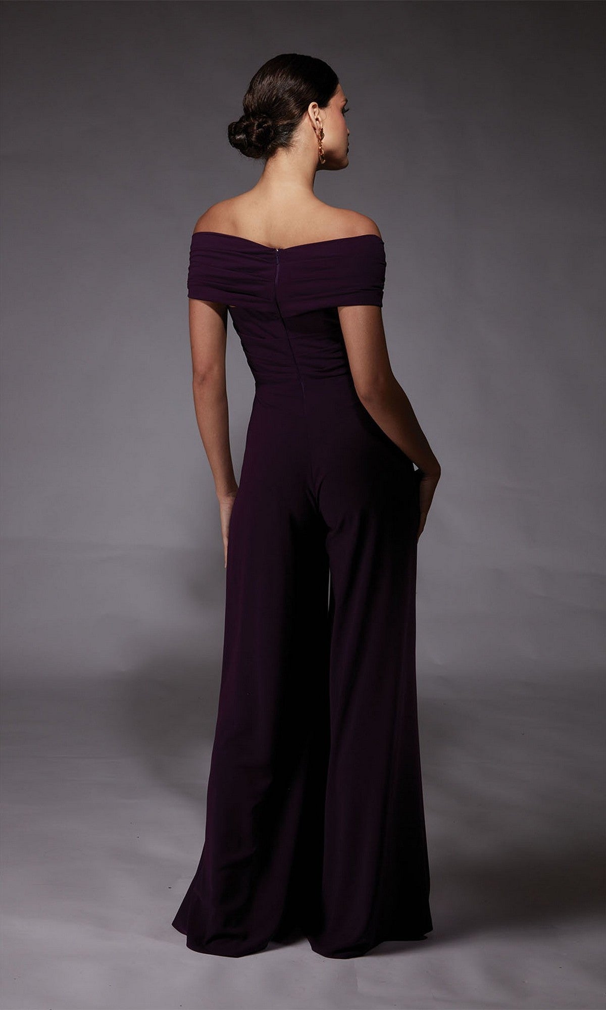 Back view of a woman in the Alyce 70067 long formal dress in dark purple, featuring an elegant off-the-shoulder design and wide-leg pants.